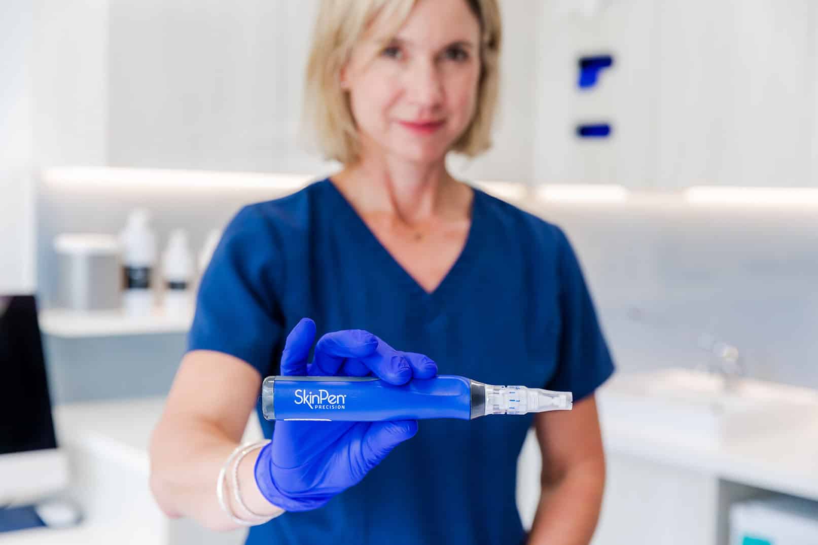 Austin Clinic staff member holding a SkinPen up to the camera