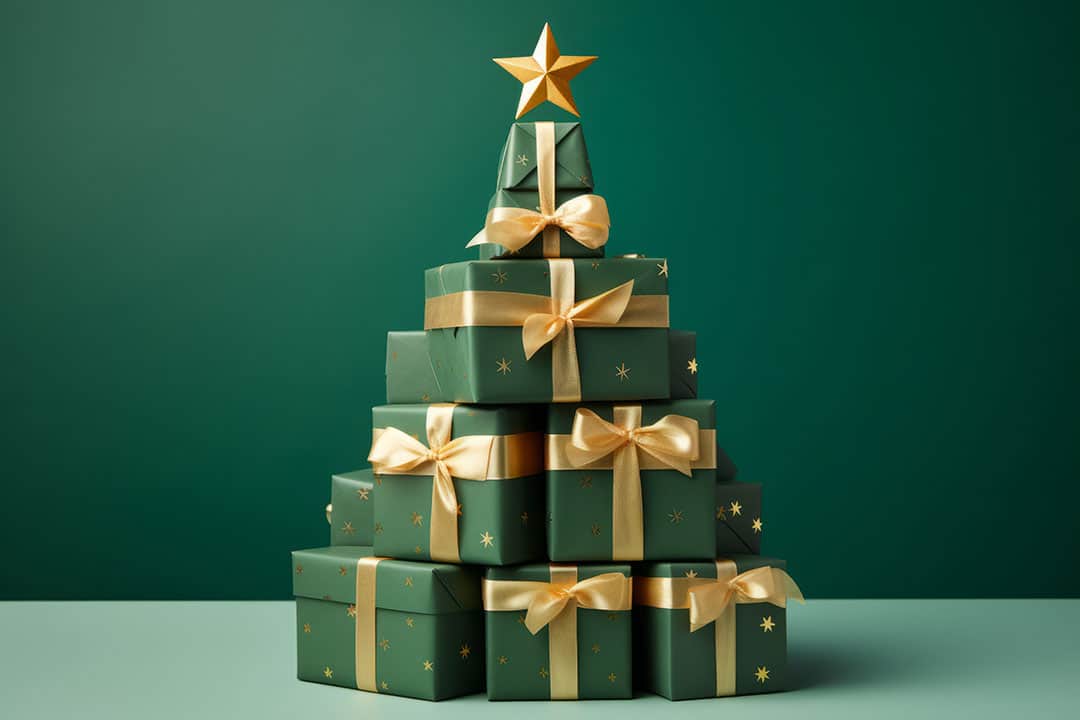 A stack of Christmas gifts wrapped in green paper and forming the shape of a Christmas tree
