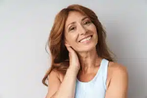 Mature woman tilting her head and smiling at the camera