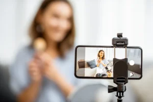 A young woman recording social media content on a smartphone