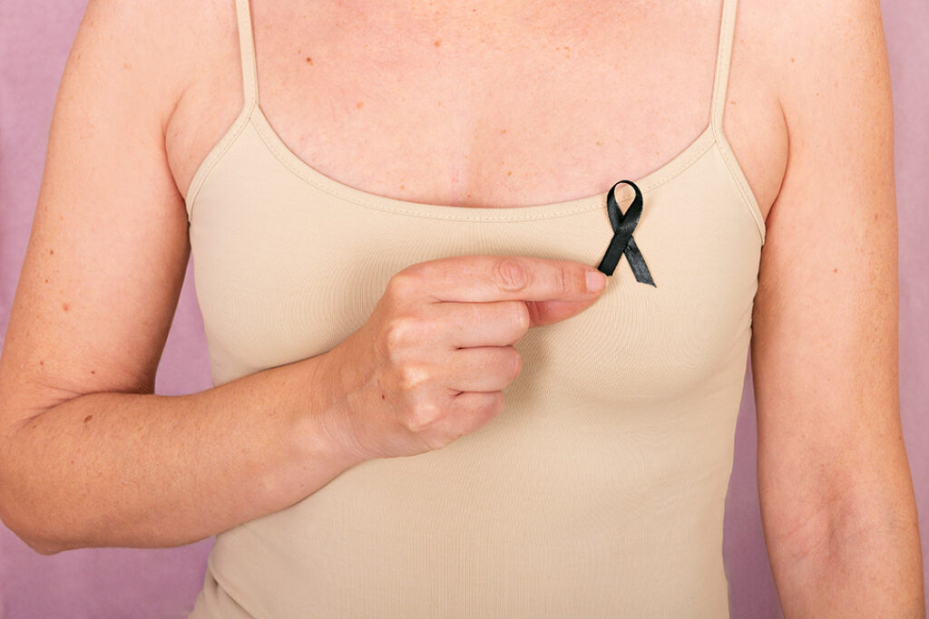 Woman holding a black ribbon over her heart